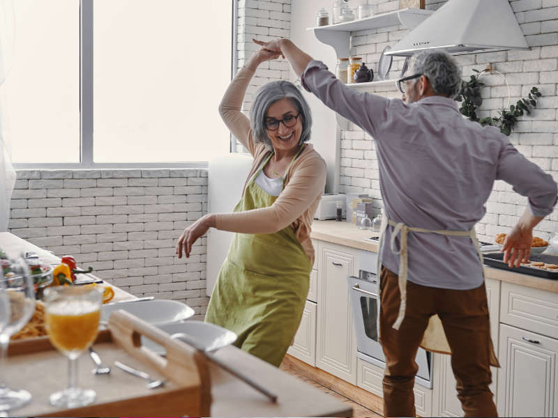 Senior couple dancing in the kitchen