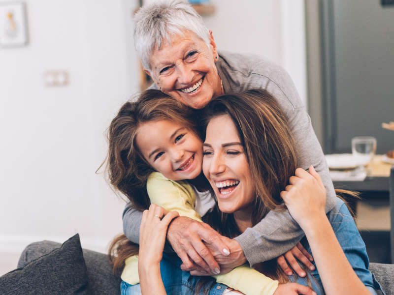 Mother, grandmother, granddaughter happily embracing